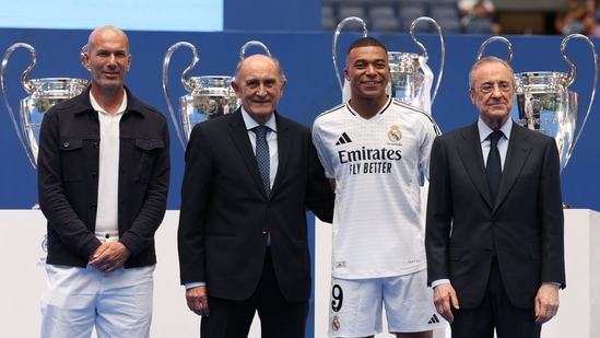 Kylian Mbappe (2ndR) poses with French legend Zinedine Zidane (L), Jose Martinez Pirri (2ndL) and Florentino Perez during his first appearance as a Real Madrid player at the Santiago Bernabeu Stadium (AFP)