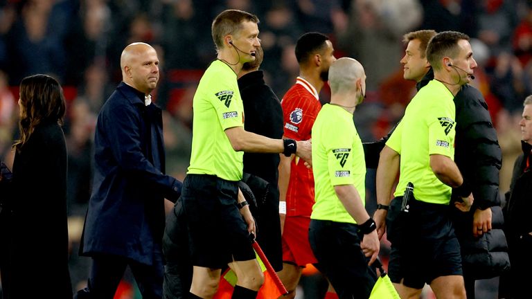 Arne Slot looks on as referee David Coote (Rt) leaves the pitch with the assistant referees after the match.
Pic:Reuters