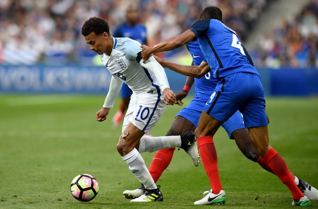 France's defender Raphael Varane (R) attempts to tackle England's midfielder Dele Alli during the international friendly football match between Fra...