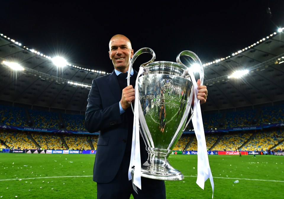 Zinedine Zidane holding the UEFA Champions League trophy.