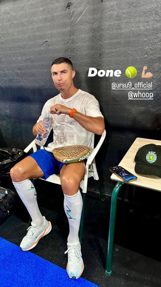 Cristiano Ronaldo sitting and drinking water after a padel match.